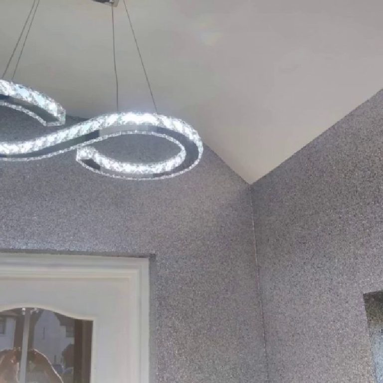 The crystal pendant light against the glittering porch walls