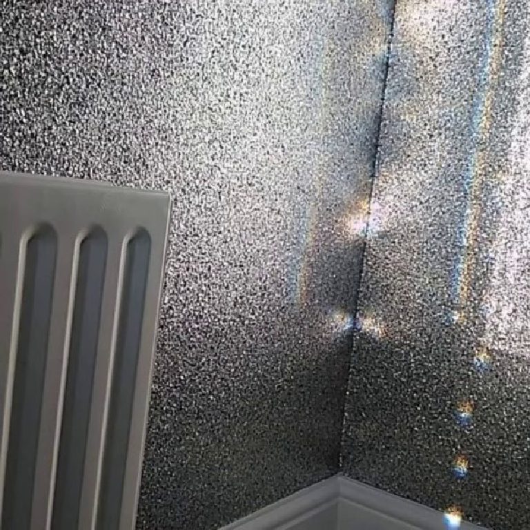 Light rays catching the silver glitter in the corner above the radiator