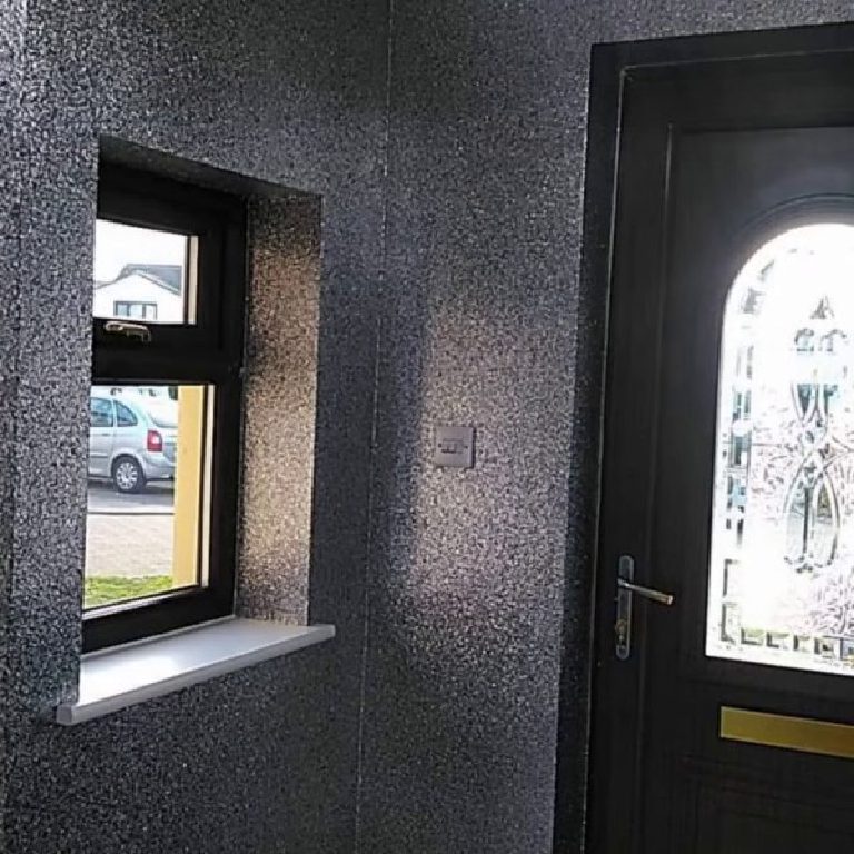 The silver glitter walls wrapping around the window and glazed door