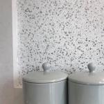The flake close up — flat silver flakes packed over a white ground