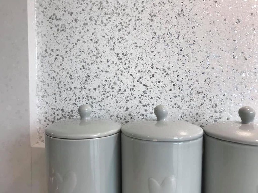 The flake close up — flat silver flakes packed over a white ground