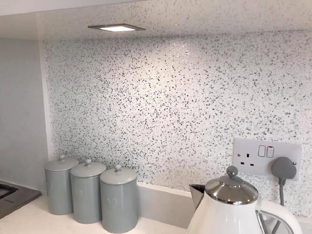 The splashback lit from the underside of the wall units