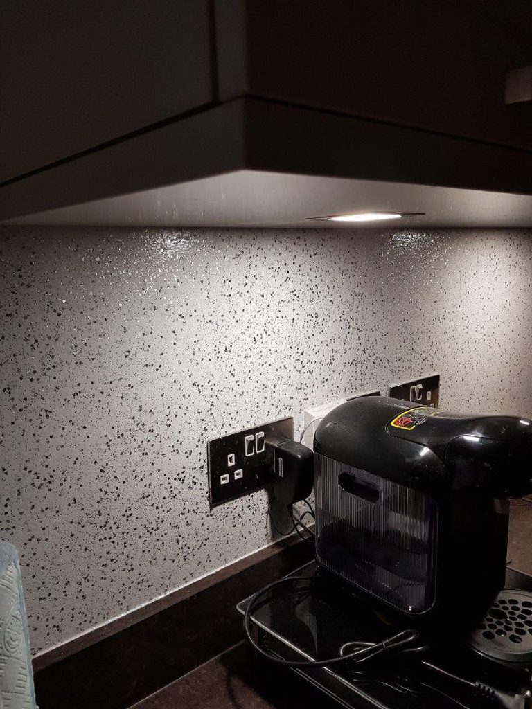 The flake wall glittering behind the coffee machine