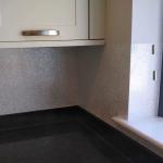 The splash back wrapping the corner over the granite