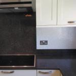 The flake splash back behind the hob and extractor
