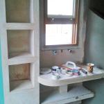 Shelving niches and vanity formed in plaster, ready for finishing