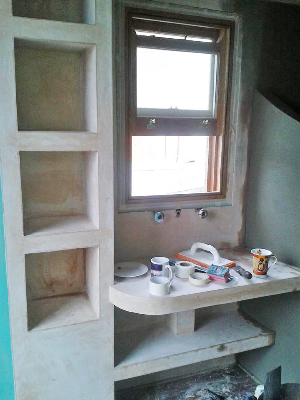 Shelving niches and vanity formed in plaster, ready for finishing