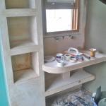 VPC plasterer working in the curved shower enclosure