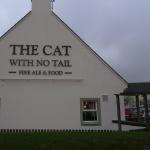 The rendered gable of The Cat With No Tail with the pub signage across it