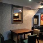 The finished corner of the bar in grey and silver Ilumitextra, with a table and stools back in place