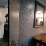 Before and after side by side — the dirt-marked painted wall on the left, the Ilumitextra finish on the right