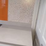 The glitter finish meeting the orange splashback beside the hob