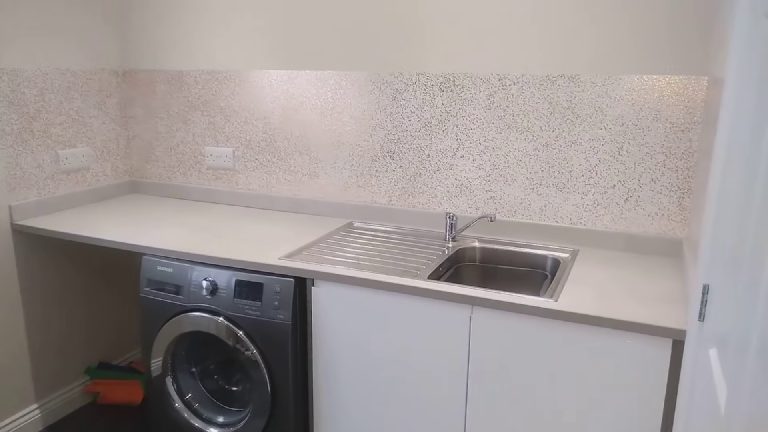The utility room with a full band of white and copper glitter above the worktop
