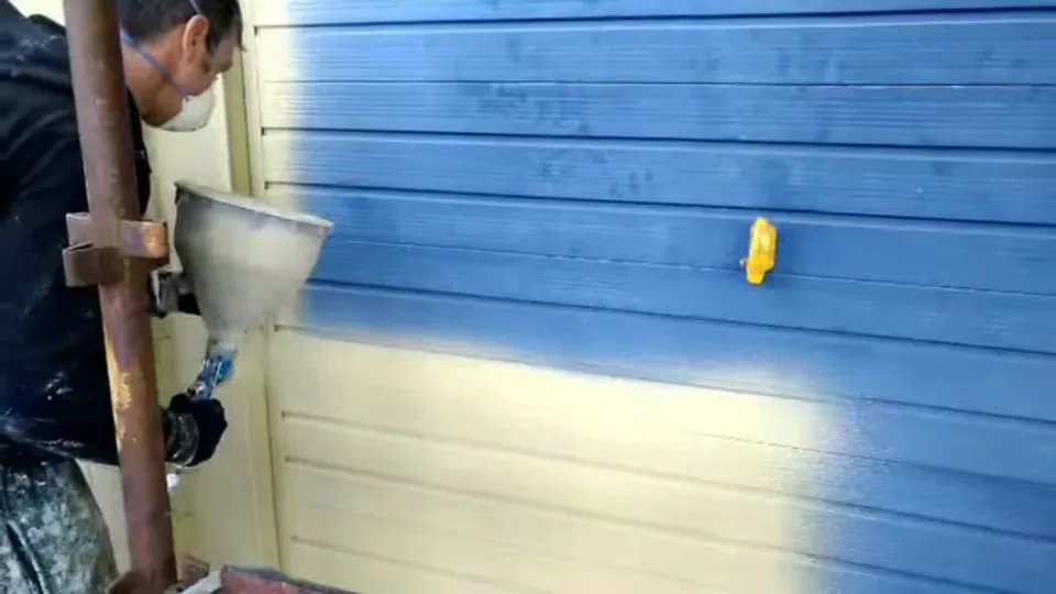First coat of CorkSol going onto a property — so we gave the garage door a fresh new look as well.